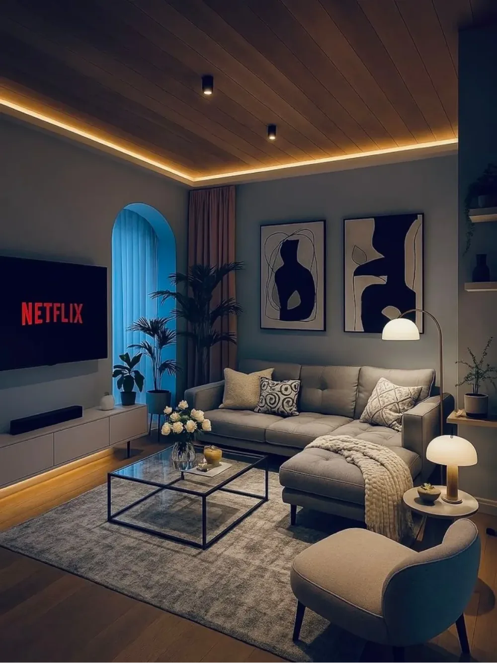 Cozy living room with sectional sofa, TV, warm ceiling lighting, and soft neutral decor
