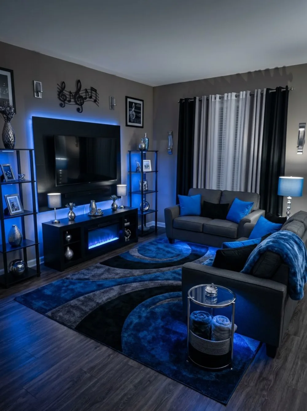 Moody living room with dark furniture, blue accent lighting, patterned rug, and cozy seating