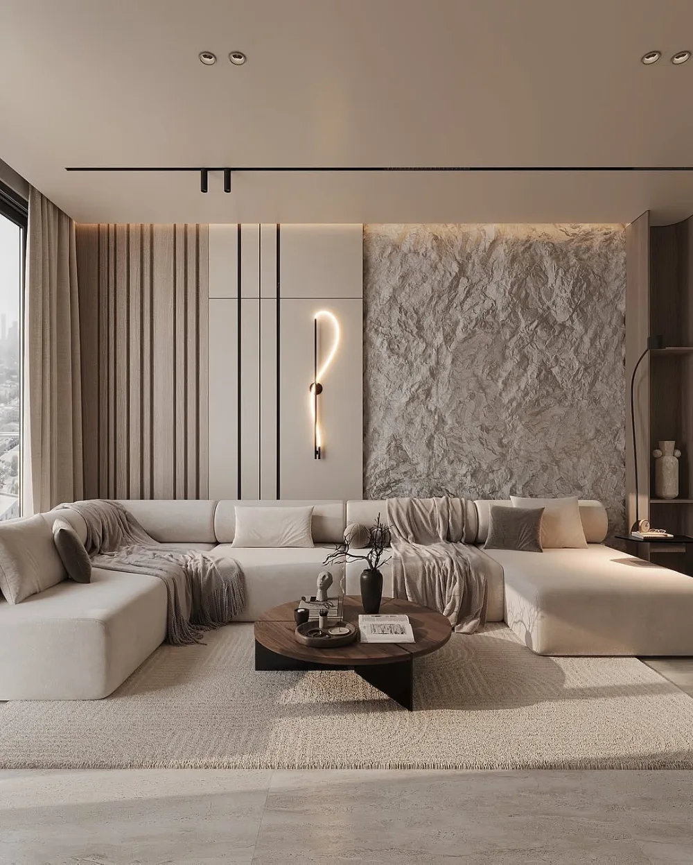 Neutral luxury living room with a large sectional sofa, textured stone wall, and sculptural wall light