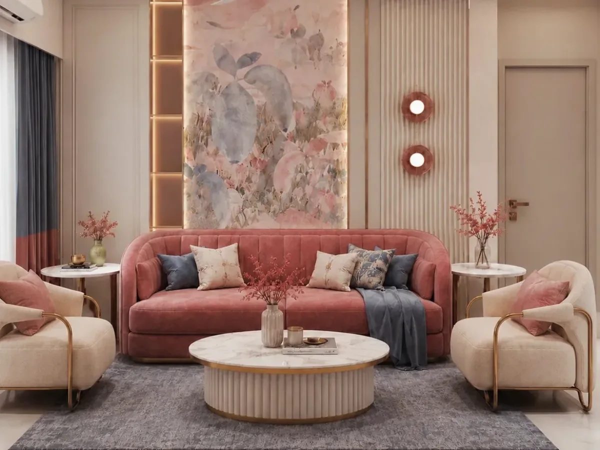 Blush pink luxury living room with curved sofa, marble coffee table, floral wall art, gold accents, and soft neutral furnishings.