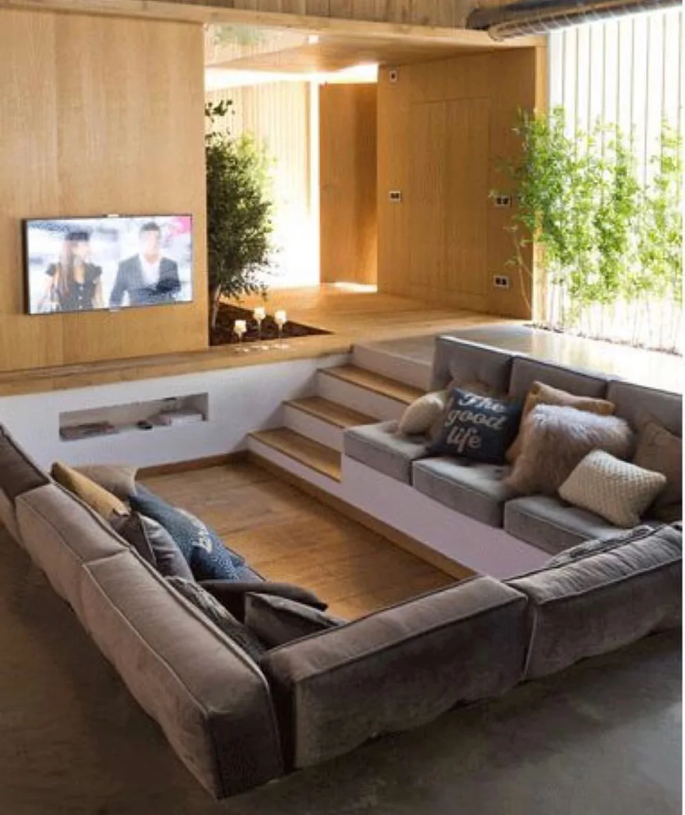 Cozy sunken living room with a large sectional sofa and warm wood accents