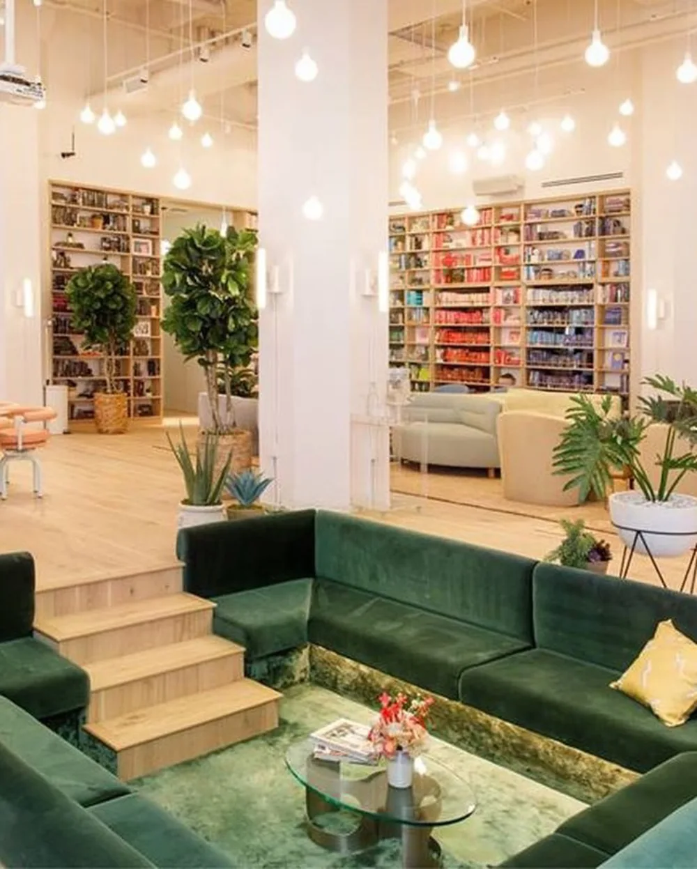 Green sunken living room with plush sectional seating and built-in bookshelves