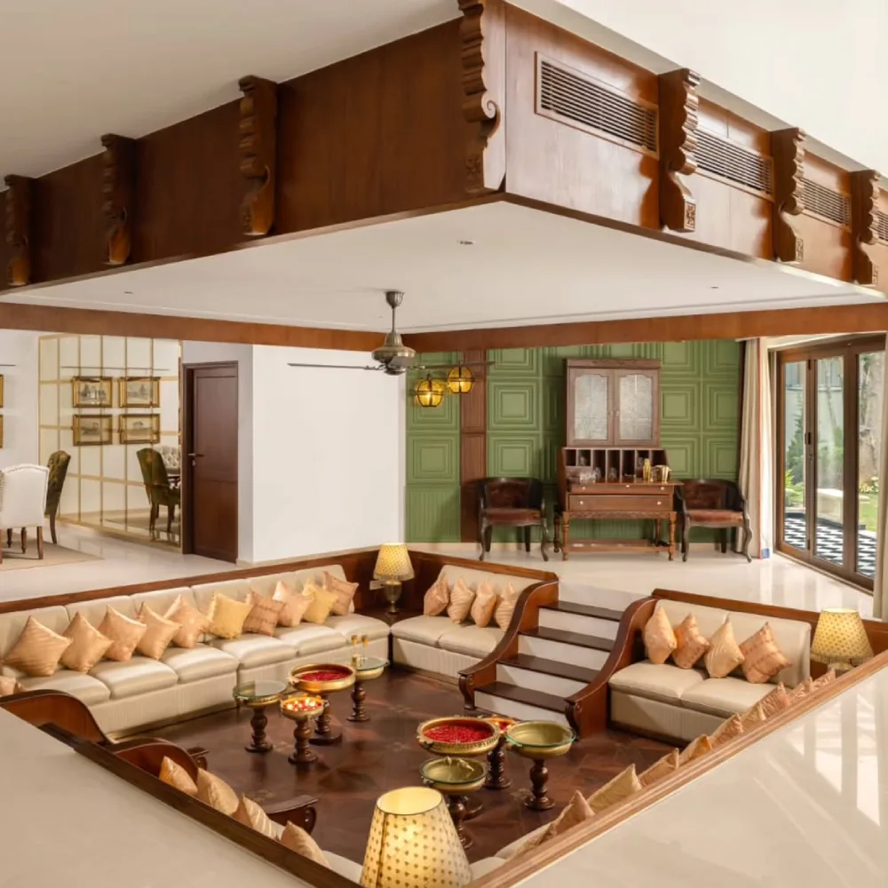 Traditional sunken living room with cream sofas and ornate wood details