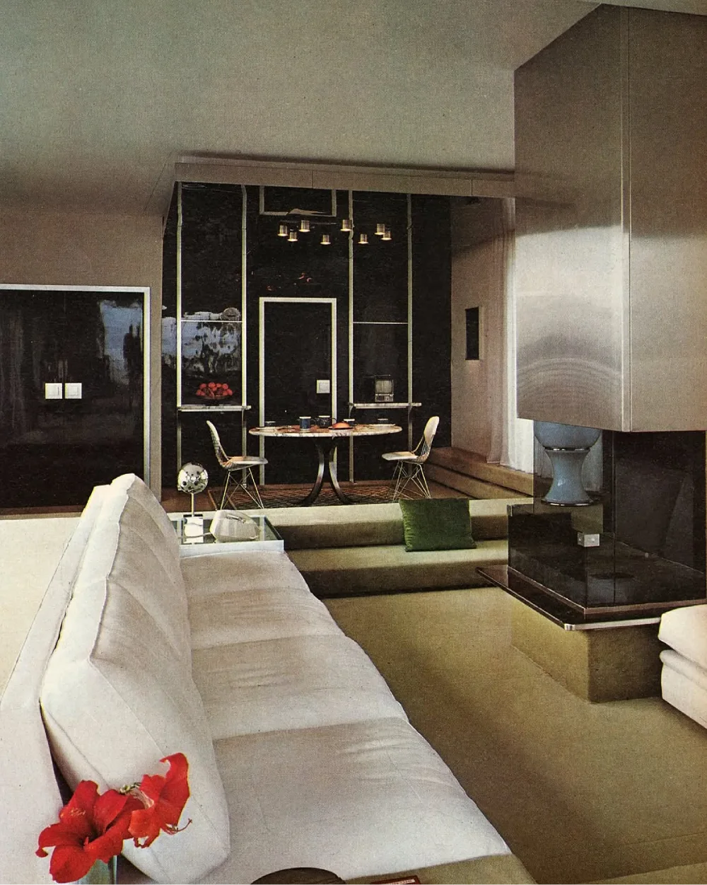 Dark sunken living room with white seating and black wall accents