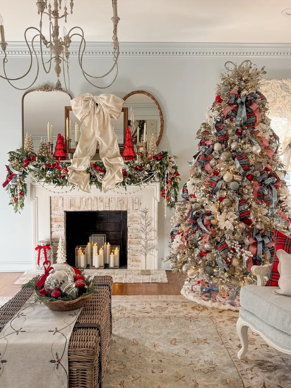 Elegant Christmas living room with a large cream bow on the mantel and decorated tree