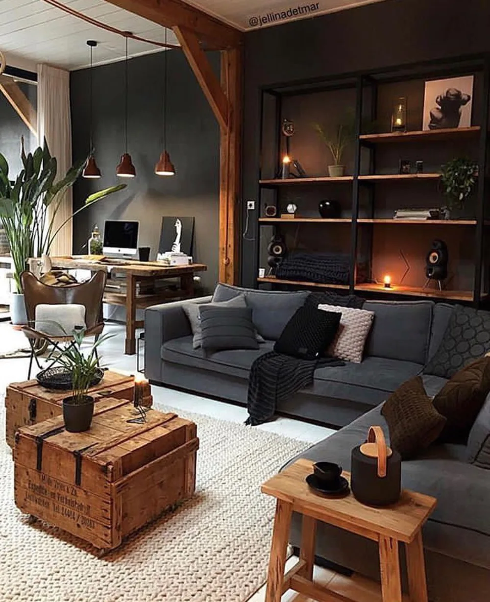 Industrial moody living room with charcoal sofas, black metal shelving, exposed wooden beams, and rustic furniture