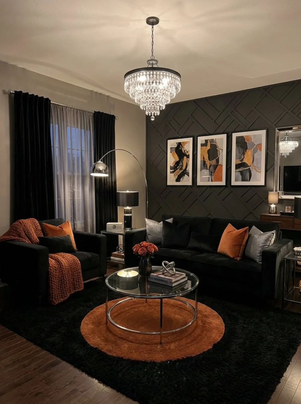 Dramatic living room with black sofas, a dark textured accent wall, burnt orange pillows, and a round orange rug