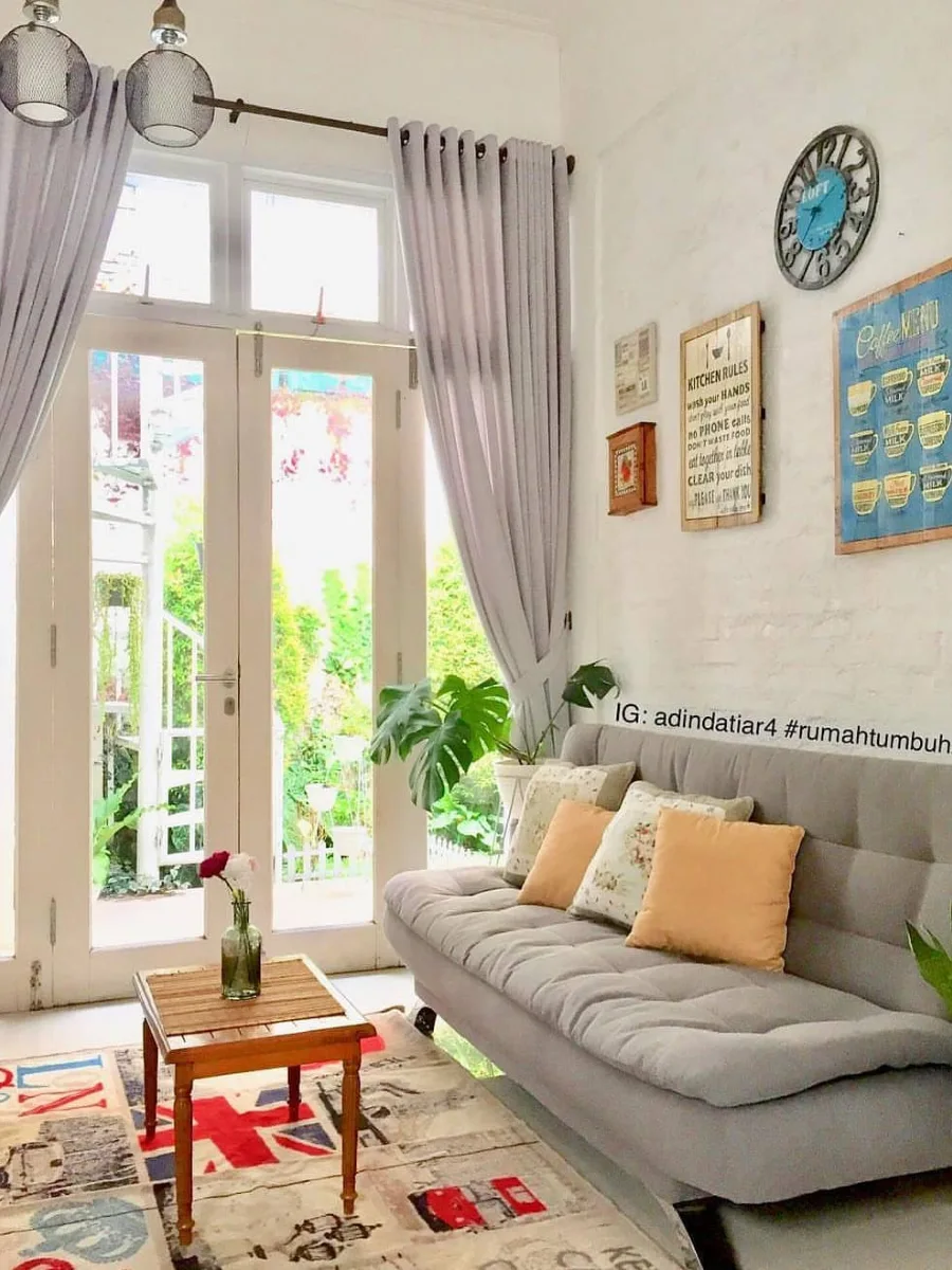 Small neutral living room with a compact sofa, round coffee table, and woven rug