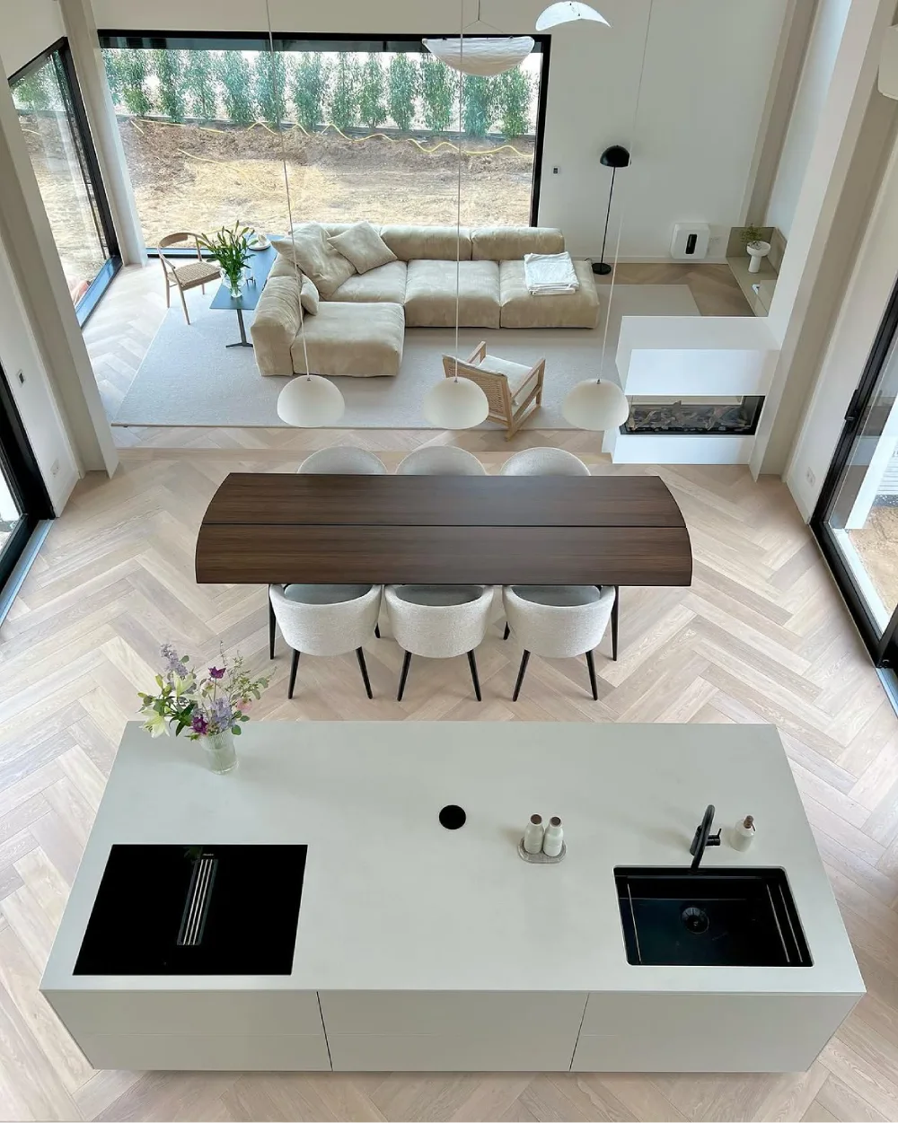 Open-concept kitchen, dining area, and living room viewed from above