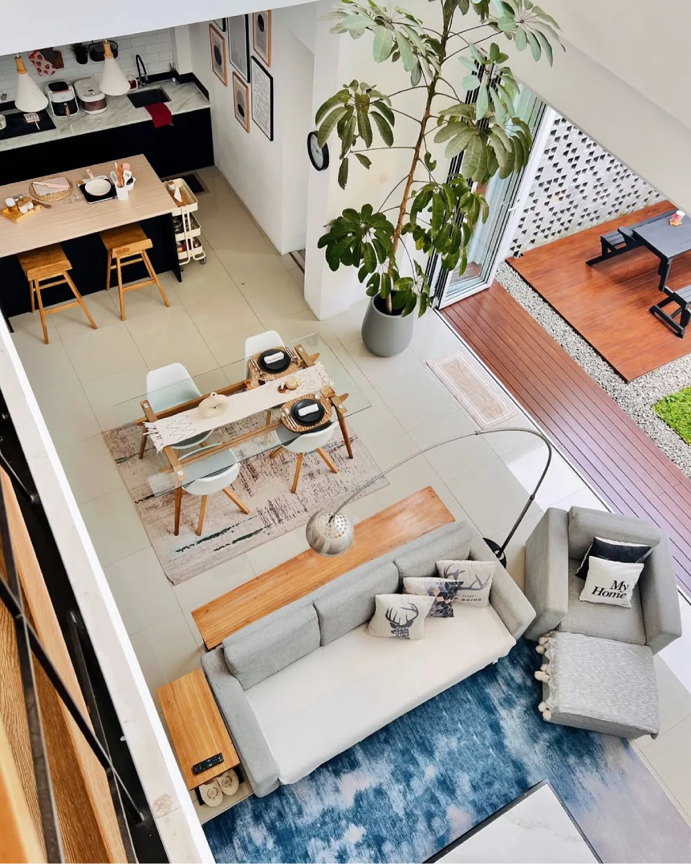 Open-concept living room and dining area connected to an outdoor wooden deck