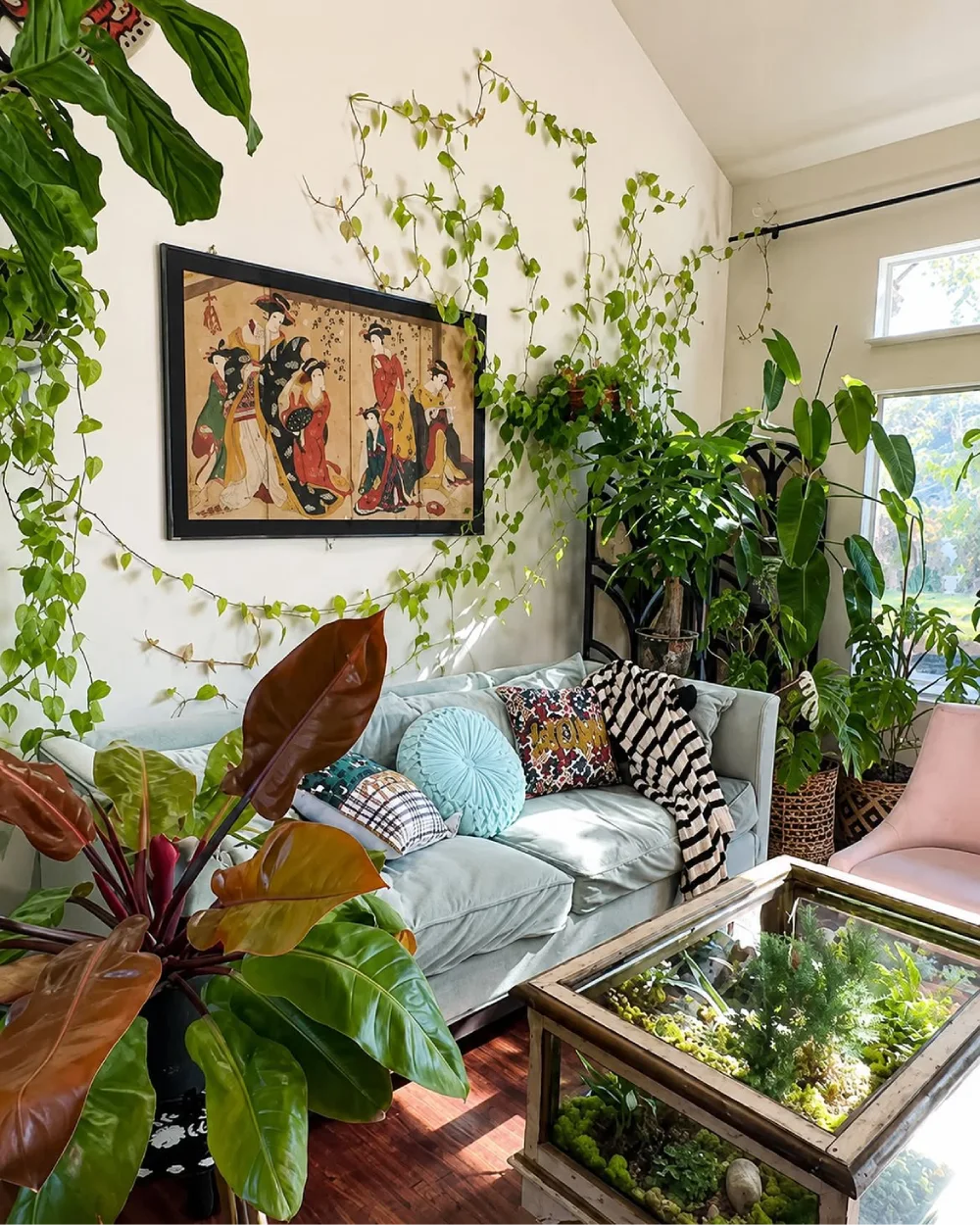 lush living room with trailing plants surrounding framed wall art