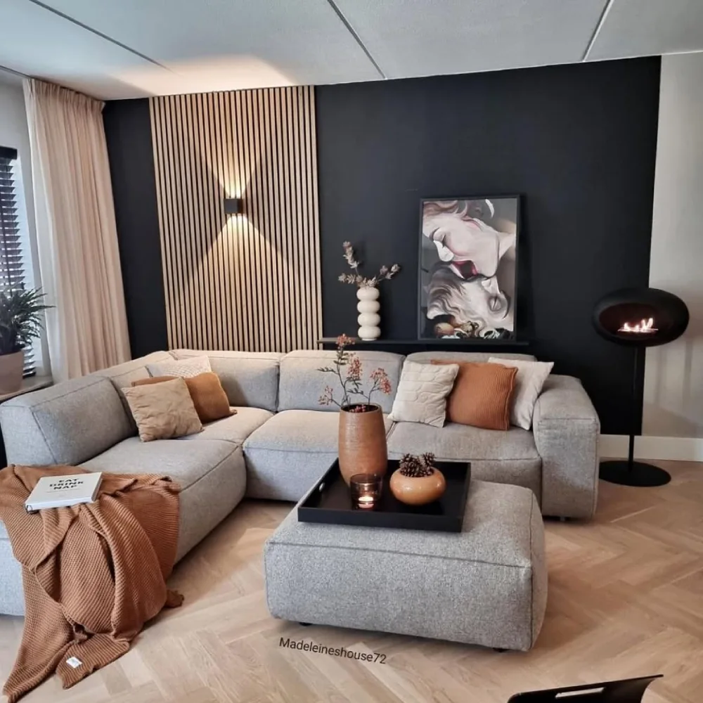 Warm gray sectional with brown wood accents and terracotta pillows in a modern living room