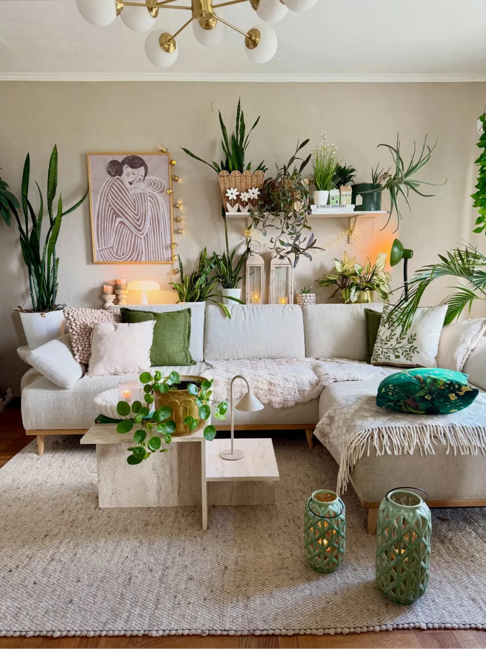 Cozy neutral living room with plants, cream sectional, layered pillows, and woven decor