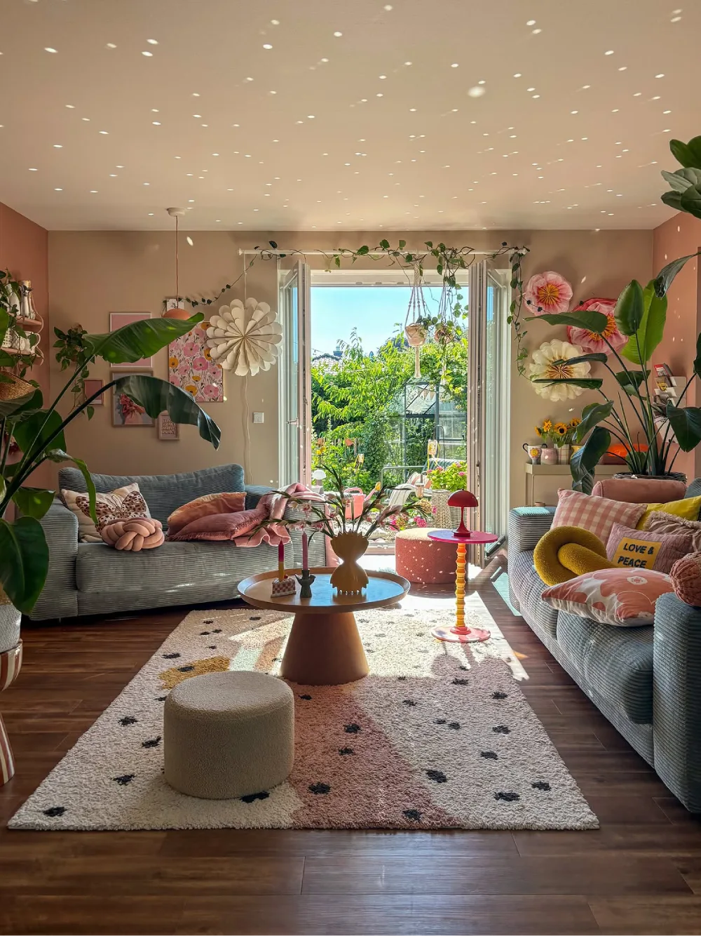 Cheerful living room with pastel furniture, colorful decor, and abundant plants