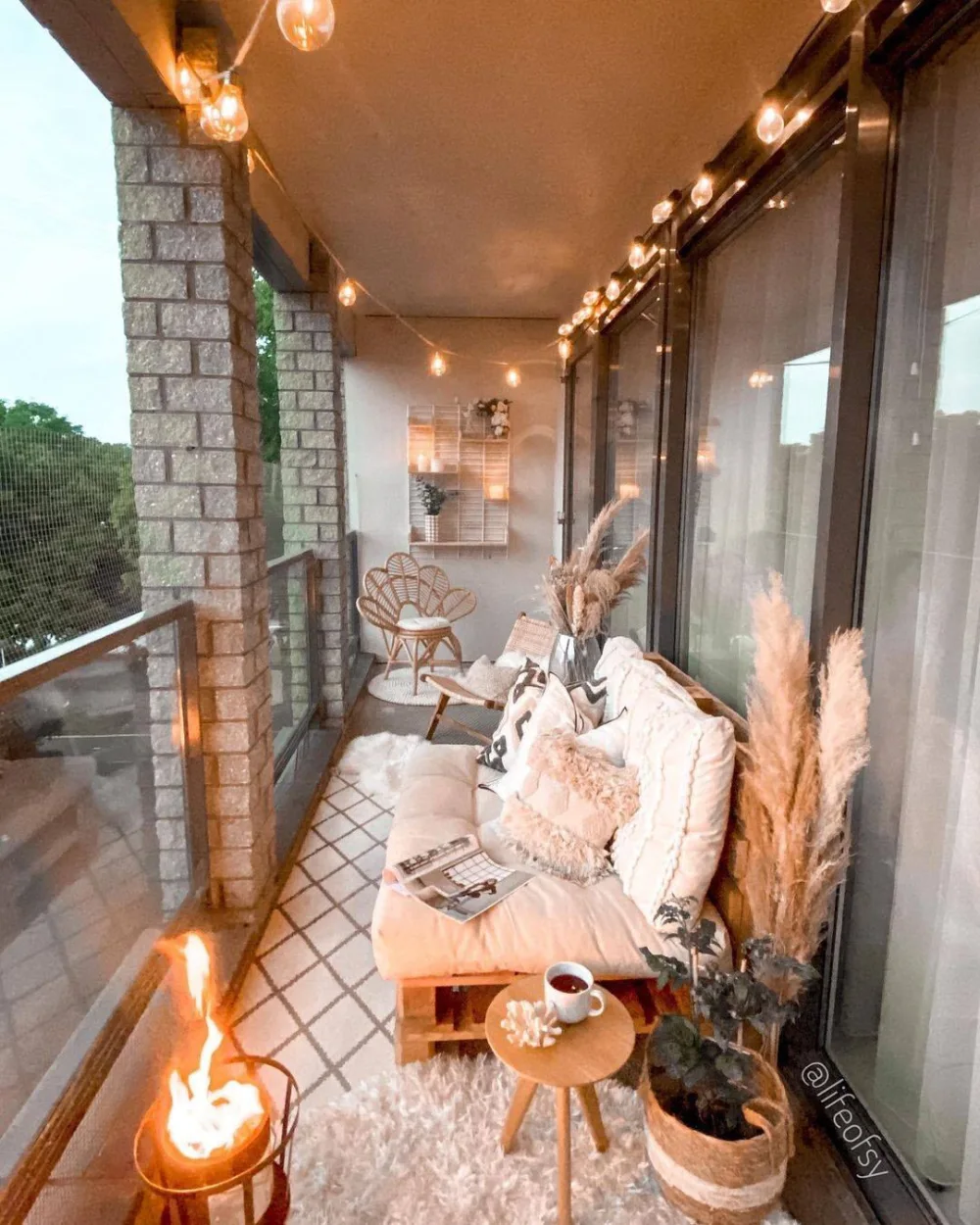 cozy covered balcony with string lights and cushioned seating