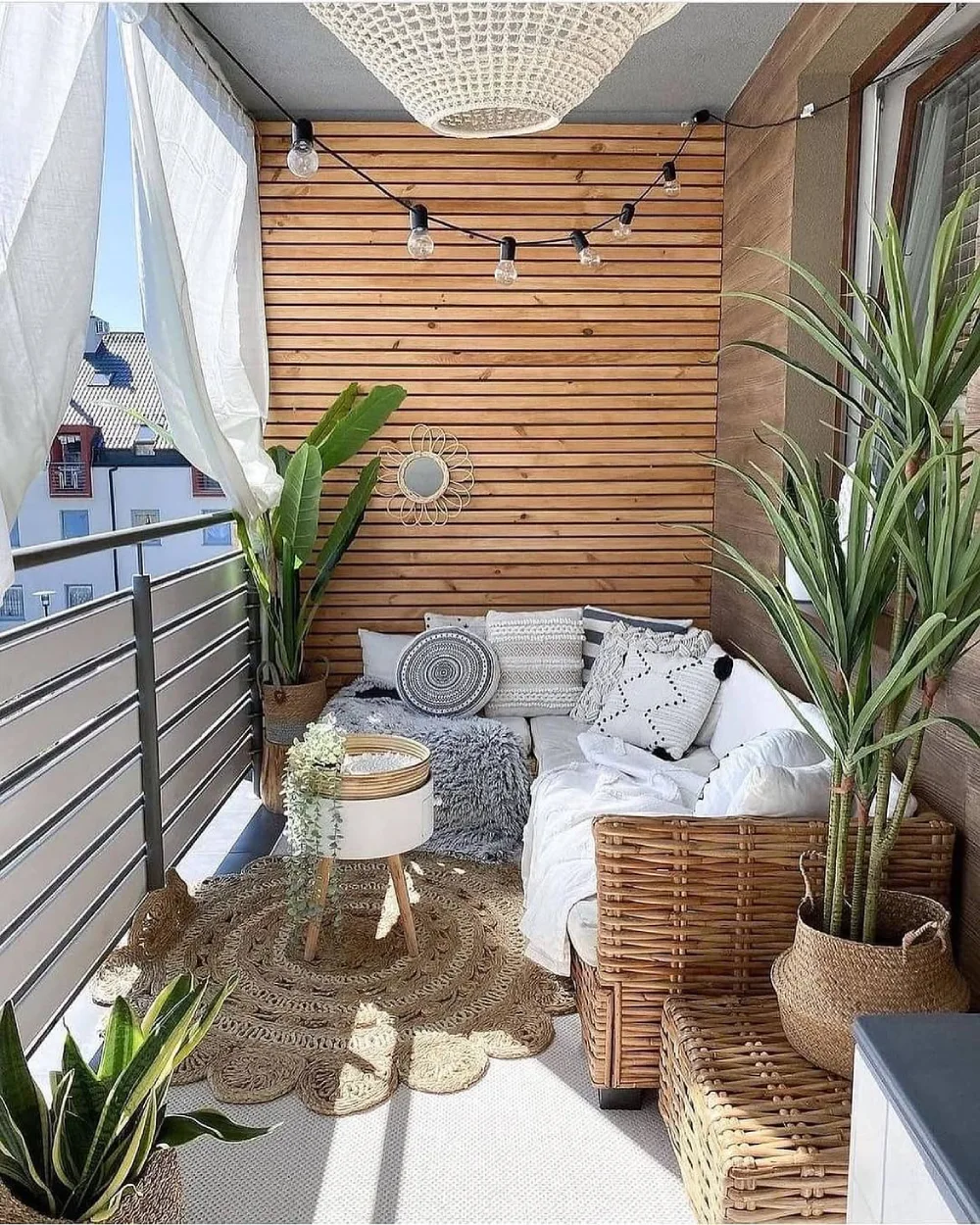 boho balcony with wood paneling, wicker furniture, plants, and string lights